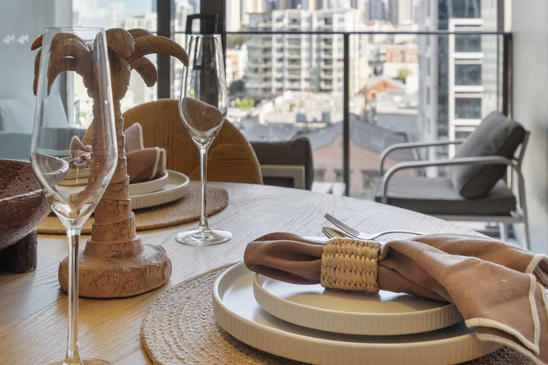 Table set for two on a balcony overlooking the Fortitude Valley skyline