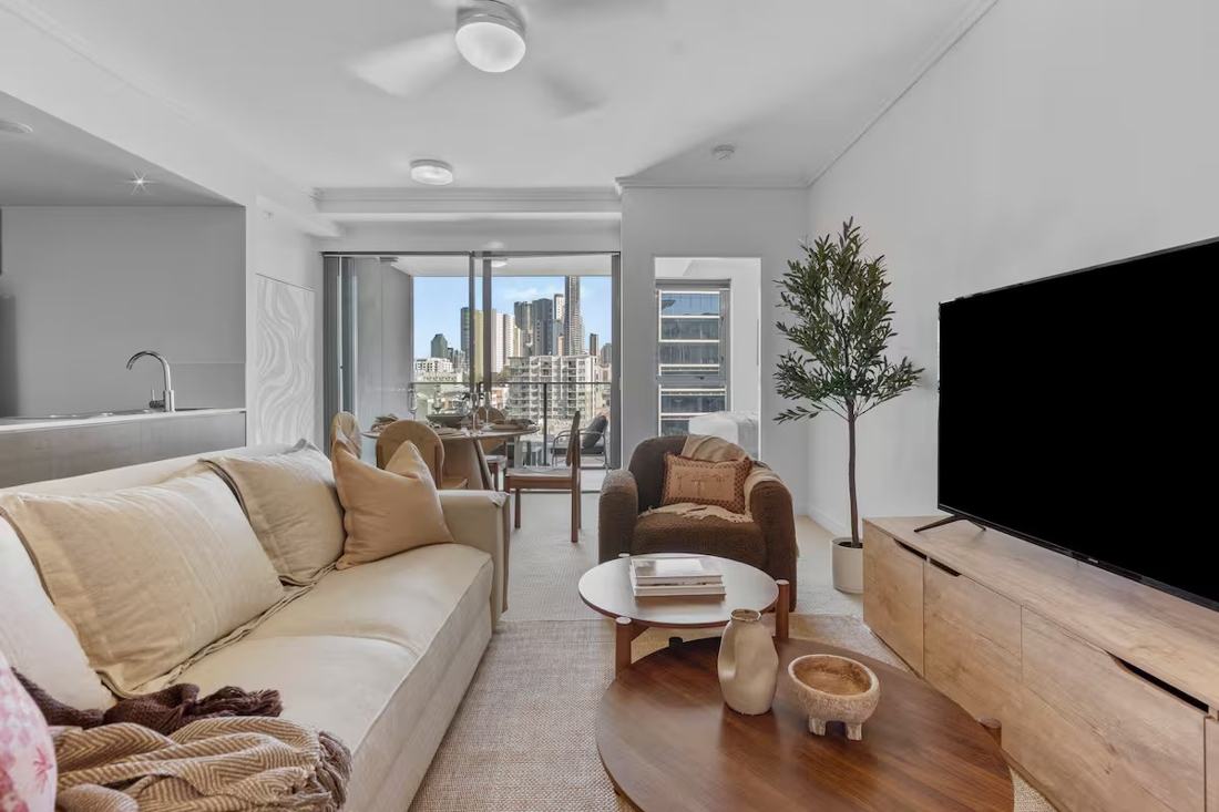 Warmly styled Gratia Stayz living room with a Fortitude Valley skyline view